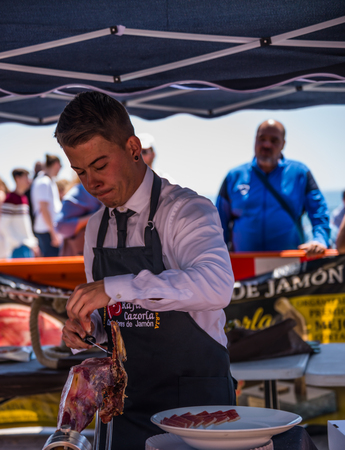 NERJA, SPAIN - APRIL 15, 2018 Traditional competition of professionals in the Jamon Serrano cutting event taking place in Nerja, Andalusia, a great demonstration of skillsのeditorial素材