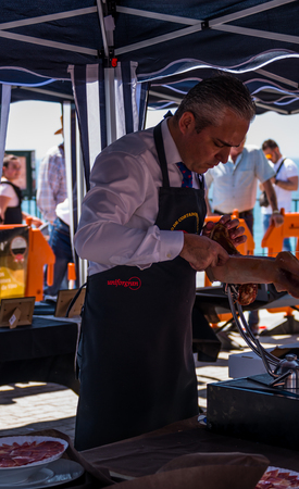 NERJA, SPAIN - APRIL 15, 2018 Traditional competition of professionals in the Jamon Serrano cutting event taking place in Nerja, Andalusia, a great demonstration of skillsのeditorial素材