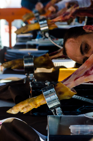 NERJA, SPAIN - APRIL 15, 2018 Traditional competition of professionals in the Jamon Serrano cutting event taking place in Nerja, Andalusia, a great demonstration of skillsのeditorial素材