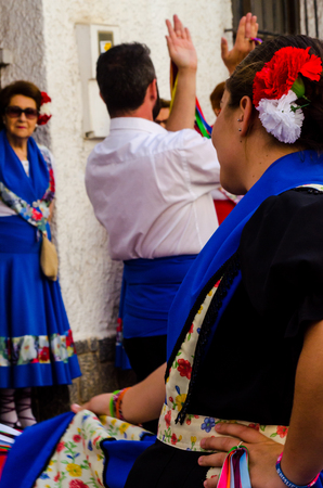 NERJA, SPAIN - MAY 04, 2018 people participating in a traditional folk dance in the street, typical Spanish costumesのeditorial素材