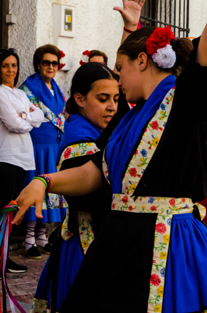 NERJA, SPAIN - MAY 04, 2018 people participating in a traditional folk dance in the street, typical Spanish costumesのeditorial素材