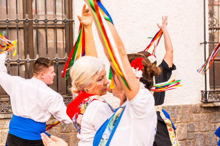 NERJA, SPAIN - MAY 04, 2018 people participating in a traditional folk dance in the street, typical Spanish costumesのeditorial素材