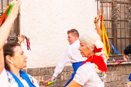 NERJA, SPAIN - MAY 04, 2018 people participating in a traditional folk dance in the street, typical Spanish costumesのeditorial素材