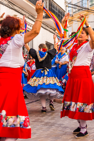 NERJA, SPAIN - MAY 04, 2018 people participating in a traditional folk dance in the street, typical Spanish costumesのeditorial素材