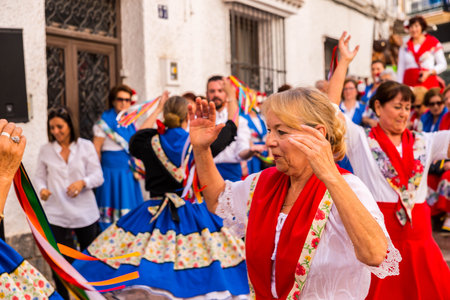 NERJA, SPAIN - MAY 04, 2018  folk dance show by a group of people on the street in a seaside Spanish townのeditorial素材