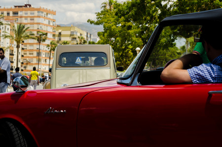 TORRE DEL MAR, SPAIN - JUNE 3, 2018 Old antique cars issued for tourists visiting a seaside town in Spainのeditorial素材