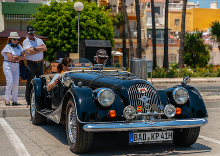TORRE DEL MAR, SPAIN - JUNE 3, 2018 Old antique cars issued for tourists visiting a seaside town in Spainのeditorial素材