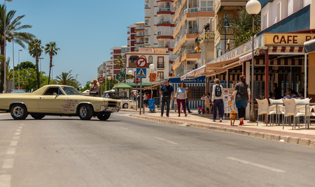 TORRE DEL MAR, SPAIN - JUNE 3, 2018 Old antique cars issued for tourists visiting a seaside town in Spainのeditorial素材