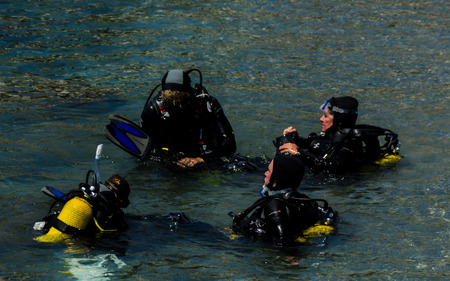 LA HERRADURA, SPAIN - JUNE 14, 2018 People on the water preparing for immersion and discovering the underwater world, active sportのeditorial素材