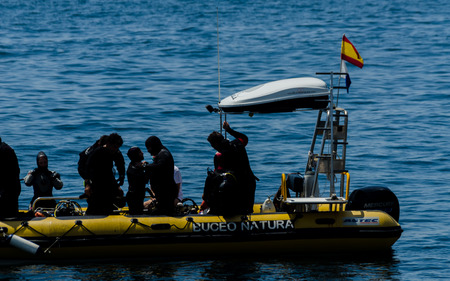 LA HERRADURA, SPAIN - JUNE 14, 2018 People on a pontoon preparing to dive and discover the underwater world, active sportのeditorial素材