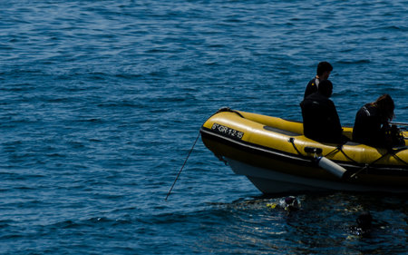 LA HERRADURA, SPAIN - JUNE 14, 2018 People on a pontoon preparing to dive and discover the...