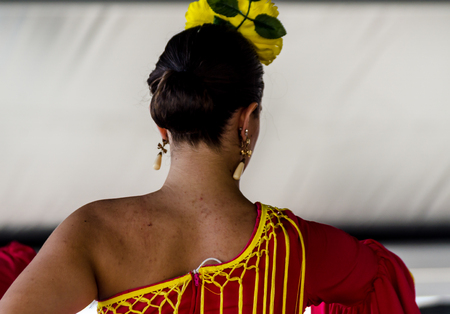 TORRE DEL MAR, SPAIN - JULY 22, 2018 show of Latin dance performed by a dance group in the rhythm of Spanish music, youth in folk costumes performing in front of the audience, dance showのeditorial素材