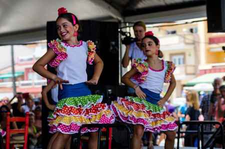TORRE DEL MAR, SPAIN - JULY 22, 2018 show of Latin dance performed by a dance group in the rhythm of Spanish music, children in folk costumes performing in front of the audience, dance showのeditorial素材