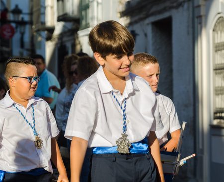 NERJA, SPAIN - JULY 16, 2018 people participating in the celebration of the Catholic ceremony of...
