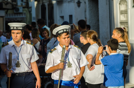 NERJA, SPAIN - JULY 16, 2018 people participating in the celebration of the Catholic ceremony of transferring the holy figure in Spain. The 'Virgen del Carmen' is the patron saint and protector of fishermen and sailorsのeditorial素材