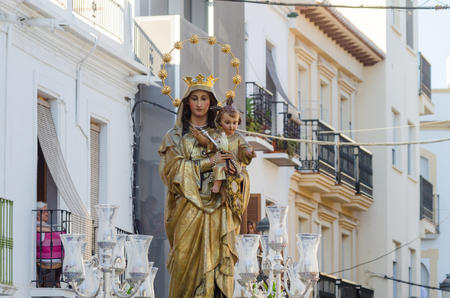 NERJA, SPAIN - JULY 16, 2018 people participating in the celebration of the Catholic ceremony of transferring the holy figure in Spain. The 'Virgen del Carmen' is the patron saint and protector of fishermen and sailorsのeditorial素材