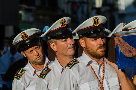 NERJA, SPAIN - JULY 16, 2018 people participating in the celebration of the Catholic ceremony of transferring the holy figure in Spain. The 'Virgen del Carmen' is the patron saint and protector of fishermen and sailorsのeditorial素材