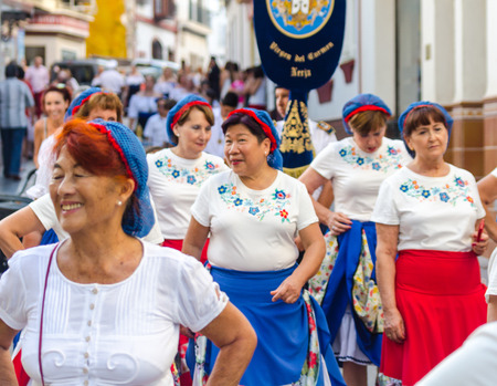 NERJA, SPAIN - JULY 16, 2018 people participating in the celebration of the Catholic ceremony of transferring the holy figure in Spain. The 'Virgen del Carmen' is the patron saint and protector of fishermen and sailorsのeditorial素材