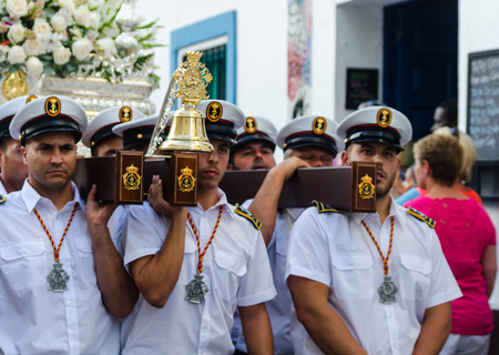 NERJA, SPAIN - JULY 16, 2018 people participating in the celebration of the Catholic ceremony of transferring the holy figure in Spain. The 'Virgen del Carmen' is the patron saint and protector of fishermen and sailorsのeditorial素材