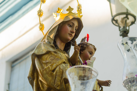 NERJA, SPAIN - JULY 16, 2018 people participating in the celebration of the Catholic ceremony of transferring the holy figure in Spain. The 'Virgen del Carmen' is the patron saint and protector of fishermen and sailorsのeditorial素材
