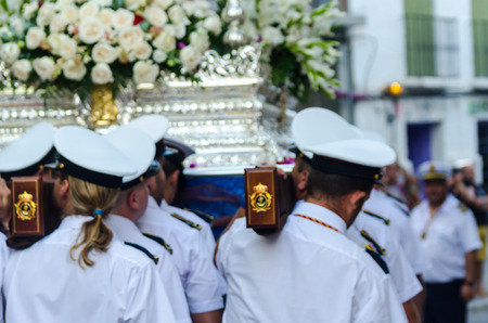 NERJA, SPAIN - JULY 16, 2018 people participating in the celebration of the Catholic ceremony of transferring the holy figure in Spain. The 'Virgen del Carmen' is the patron saint and protector of fishermen and sailorsのeditorial素材