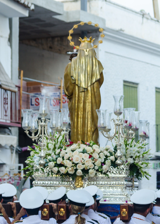 NERJA, SPAIN - JULY 16, 2018 people participating in the celebration of the Catholic ceremony of transferring the holy figure in Spain. The 'Virgen del Carmen' is the patron saint and protector of fishermen and sailorsのeditorial素材
