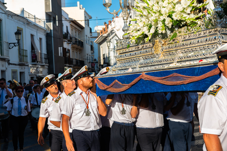 NERJA, SPAIN - JULY 16, 2018 people participating in the celebration of the Catholic ceremony of transferring the holy figure in Spain. The 'Virgen del Carmen' is the patron saint and protector of fishermen and sailorsのeditorial素材