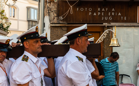 NERJA, SPAIN - JULY 16, 2018 people participating in the celebration of the Catholic ceremony of transferring the holy figure in Spain. The 'Virgen del Carmen' is the patron saint and protector of fishermen and sailorsのeditorial素材