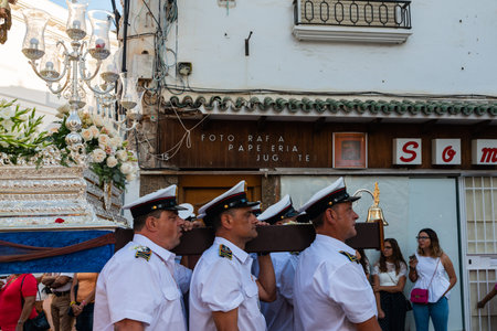 NERJA, SPAIN - JULY 16, 2018 people participating in the celebration of the Catholic ceremony of...