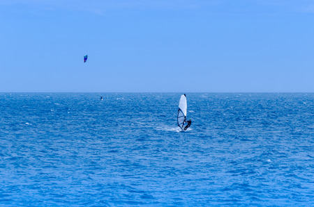 MALAGA, SPAIN - MAY 25, 2018 Windurfer on a board with a sail practicing extreme sport, active restのeditorial素材