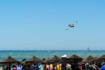 TORRE DEL MAR, SPAIN - JULY 29, 2018 planes flying over the beach in a seaside town, aerobatics airshow in Andalusiaのeditorial素材