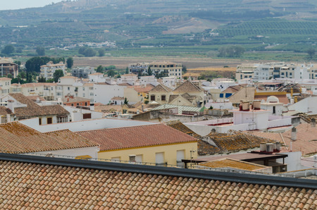VELEZ-MALAGA, SPAIN - AUGUST 17, 2018 roofs and facades of buildings in a Spanish city, characteristic architecture in the south of Spainのeditorial素材