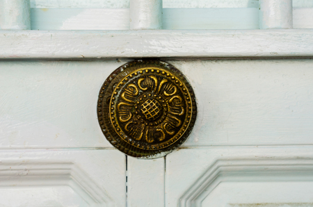 Close up on a round door handle with decorative elements, door decoration, vintageの写真素材