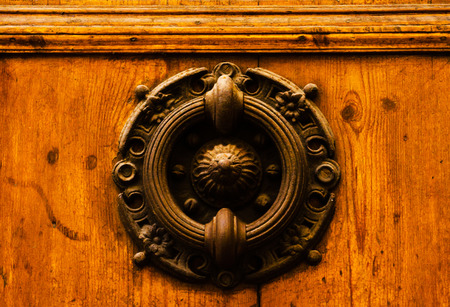 Door with brass knocker in the shape of a decor, beautiful entrance to the house, vintage decorationの写真素材