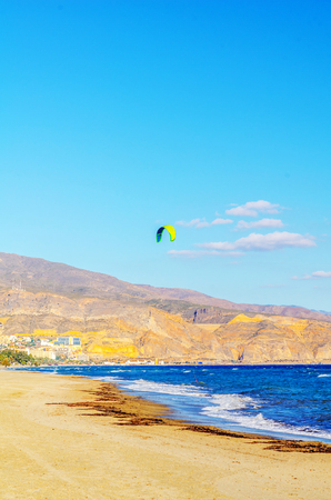 Kite boarder enjoys surfing in blue water in the bay, a place with favorable conditions for this sport, seaの写真素材