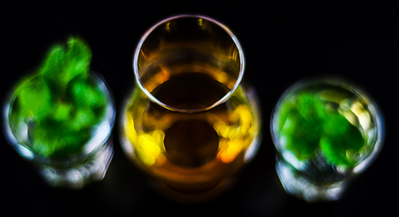 Single malt whiskey in a glass and green mint liqueur, refreshing set of drinks, taste sensationsの写真素材