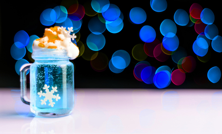 Christmas drink shot in a shot glass on a bokeh background, Christmas decoration on the bar, xmas partyの写真素材