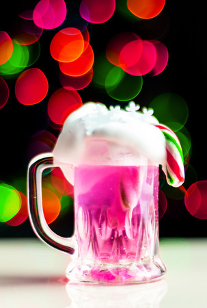 Christmas drink shot in a shot glass on a bokeh background, Christmas decoration on the bar, xmas partyの写真素材