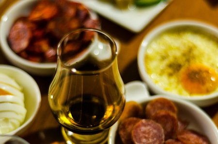 Glass of whisky single malt and set with different appetizers in small portions, delicious snacks and drinkの写真素材