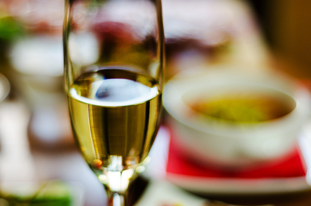 Champagne with set appetizers in small portions, healthy and delicious snacks, tasty set on blurred background.の写真素材