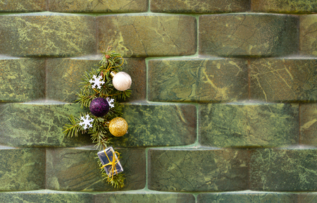 Green Christmas ornament with ball, bow and small gifts  on a wall background, xmas decorationの写真素材