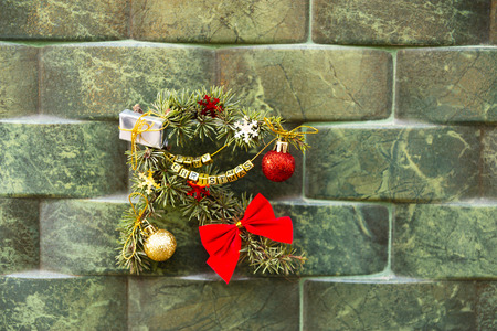 Green Christmas ornament with ball, bow and small gifts  on a wall background, xmas decorationの写真素材
