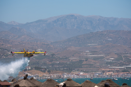 TORRE DEL MAR, SPAIN - JULY 29, 2018 planes flying over the beach in a seaside town, aerobatics airshow in Andalusiaのeditorial素材