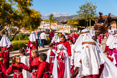 VELEZ-MALAGA, SPAIN - MARCH 27, 2018 People participating in the procession  in the Holy Week in a Spanish city, easterのeditorial素材