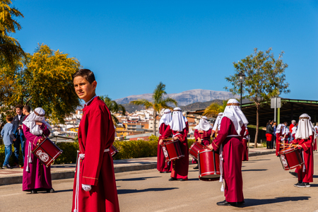 VELEZ-MALAGA, SPAIN - MARCH 27, 2018 People participating in the procession  in the Holy Week in a Spanish city, easterのeditorial素材