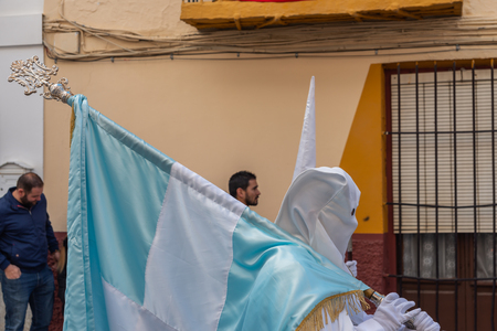 VELEZ-MALAGA, SPAIN - MARCH 25, 2018 People participating in the procession connected in a holy week in a Spanish city, easterのeditorial素材