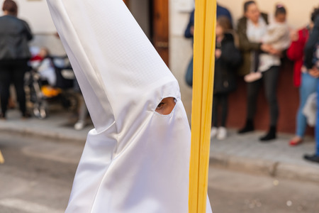 VELEZ-MALAGA, SPAIN - MARCH 25, 2018 People participating in the procession connected in a holy week in a Spanish city, easterのeditorial素材