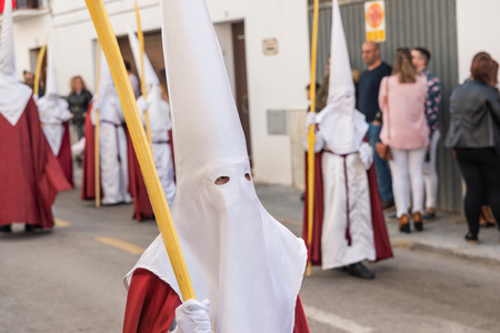 VELEZ-MALAGA, SPAIN - MARCH 25, 2018 People participating in the procession connected in a holy week in a Spanish city, easterのeditorial素材