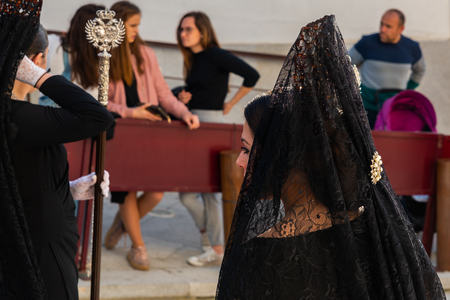 VELEZ-MALAGA, SPAIN - MARCH 29, 2018 People participating in the procession  in the Holy Week in a Spanish city, easterのeditorial素材