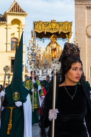 VELEZ-MALAGA, SPAIN - MARCH 29, 2018 People participating in the procession  in the Holy Week in a Spanish city, easterのeditorial素材